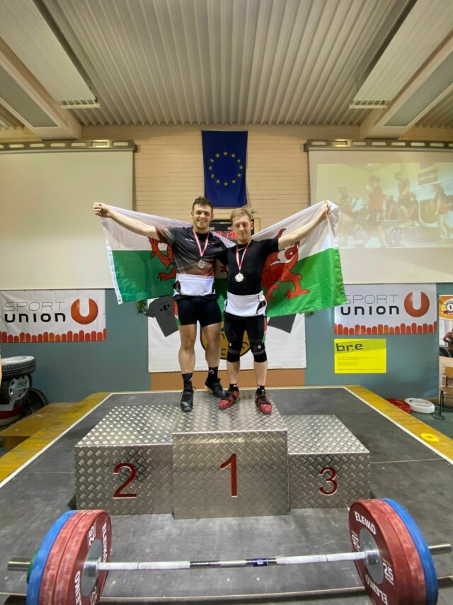 Harry Nelms and Garin Beams on the podium with their Welsh Flags at the Junior Battle 2022 min