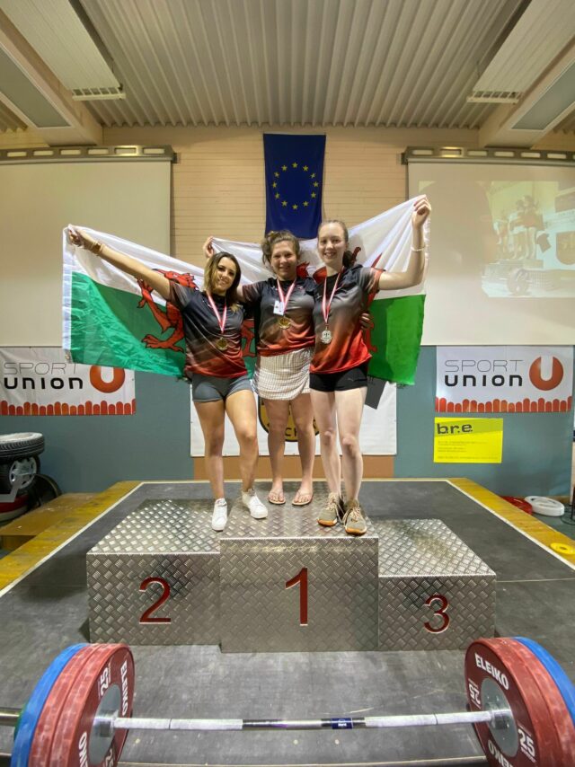 Molly Greenwood Grace Morris and Millie Lerwill on the podium with their Welsh Flags at the Junior Battle 2022 min